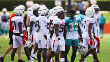 Aug 6, 2024; Miami Gardens, FL, USA; Miami Dolphins cornerback Siran Neal (33) talks to Atlanta Falcons safety Dane Cruikshank (31) during a joint practice at Baptist Health Training Complex. Mandatory Credit: Sam Navarro-USA TODAY Sports