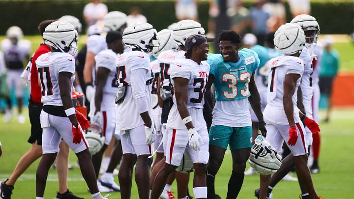 Aug 6, 2024; Miami Gardens, FL, USA; Miami Dolphins cornerback Siran Neal (33) talks to Atlanta Falcons safety Dane Cruikshank (31) during a joint practice at Baptist Health Training Complex. Mandatory Credit: Sam Navarro-USA TODAY Sports