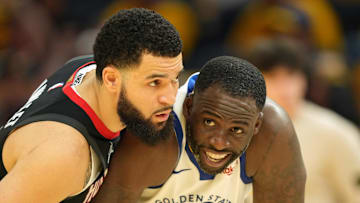 Apr 26, 2025; San Francisco, California, USA; Houston Rockets guard Fred VanVleet (left) defends against Golden State Warriors forward Draymond Green (23) during the fourth quarter of game three of first round for the 2024 NBA Playoffs at Chase Center. Mandatory Credit: Darren Yamashita-Imagn Images