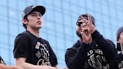 Nov 3, 2025; Los Angeles, CA, USA; Los Angeles Dodgers pitcher Roki Sasaki (left) acknowledges the crowd during the World Series championship parade at downtown Los Angeles. Mandatory Credit: Kiyoshi Mio-Imagn Images