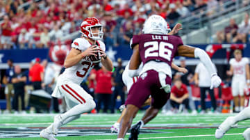 Sep 28, 2024; Arlington, Texas, USA; Arkansas Razorbacks punter Devin Bale (37) attempts a fake punt as Texas A&M Aggies defensive back Will Lee III (26) defends during the second half at AT&T Stadium. Mandatory Credit: Kevin Jairaj-Imagn Images