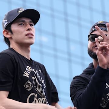 Nov 3, 2025; Los Angeles, CA, USA; Los Angeles Dodgers pitcher Roki Sasaki (left) acknowledges the crowd during the World Series championship parade at downtown Los Angeles. Mandatory Credit: Kiyoshi Mio-Imagn Images