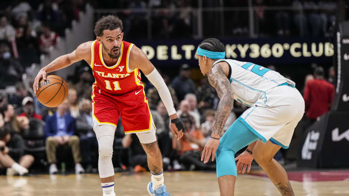 Apr 10, 2024; Atlanta, Georgia, USA; Atlanta Hawks guard Trae Young (11) dribbles against Charlotte Hornets guard Tre Mann (23) during the first half at State Farm Arena. Mandatory Credit: Dale Zanine-USA TODAY Sports