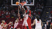 Dec 5, 2025; Houston, Texas, USA; Houston Cougars forward Kalifa Sakho (14) attempts to block a shot by Florida State Seminoles forward Shah Muhammad (4) during the first half at Toyota Center. Mandatory Credit: Troy Taormina-Imagn Images
