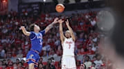 Mar 3, 2025; Houston, Texas, USA; Houston Cougars guard Milos Uzan (7) shoots the ball as Kansas Jayhawks guard Zeke Mayo (5) defends during the second half at Fertitta Center. Mandatory Credit: Troy Taormina-Imagn Images