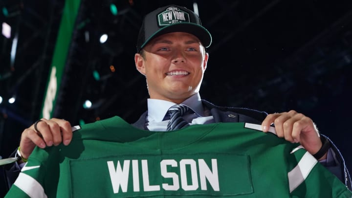 BYU quarterback Zach Wilson poses with jersey after being selected in the 2021 NFL draft.