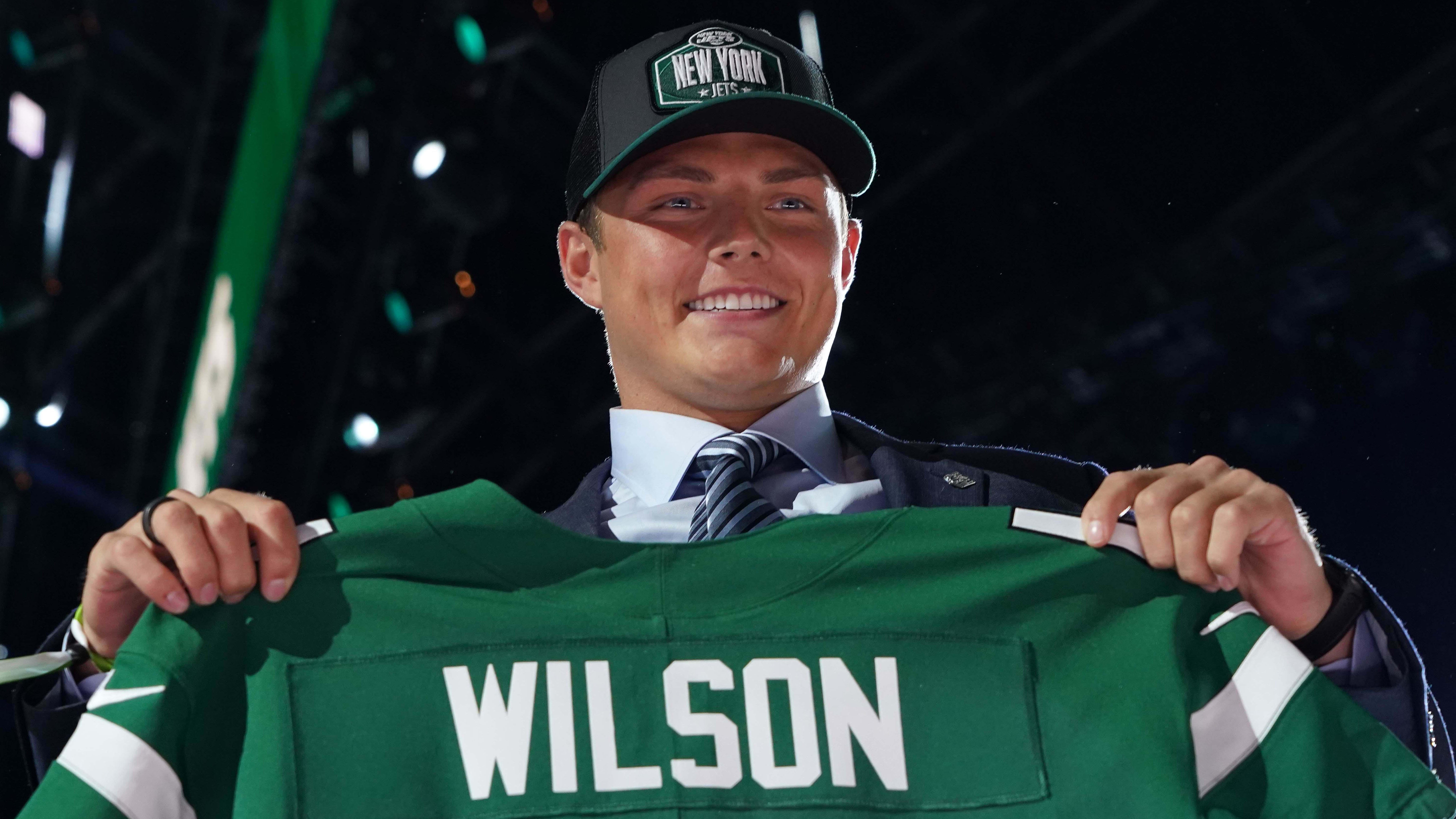 Zach Wilson with his Jets jersey on draft night in 2021