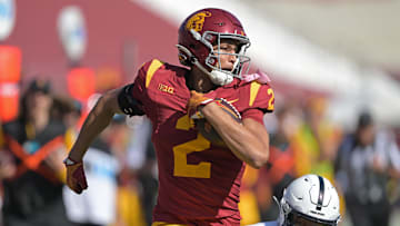 Oct 12, 2024; Los Angeles, California, USA;  USC Trojans wide receiver Duce Robinson (2) runs the ball after a complete pass before he is stopped by Penn State Nittany Lions safety Zakee Wheatley (6) in the second half at United Airlines Field at the Los Angeles Memorial Coliseum. Mandatory Credit: Jayne Kamin-Oncea-Imagn Images