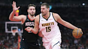 Nov 21, 2025; Houston, Texas, USA; Denver Nuggets center Nikola Jokic (15) controls the ball as Houston Rockets center Alperen Sengun (28) defends during the fourth quarter at Toyota Center. Mandatory Credit: Troy Taormina-Imagn Images