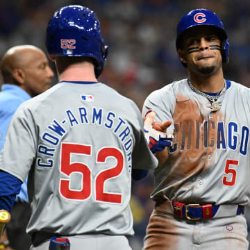 Jun 11, 2024; St. Petersburg, Florida, USA; Chicago Cubs third baseman Christopher Morel (5) celebrates with center fielder Pete Crow-Armstrong (52) after scoring a run in the sixth inning against the Tampa Bay Rays at Tropicana Field.