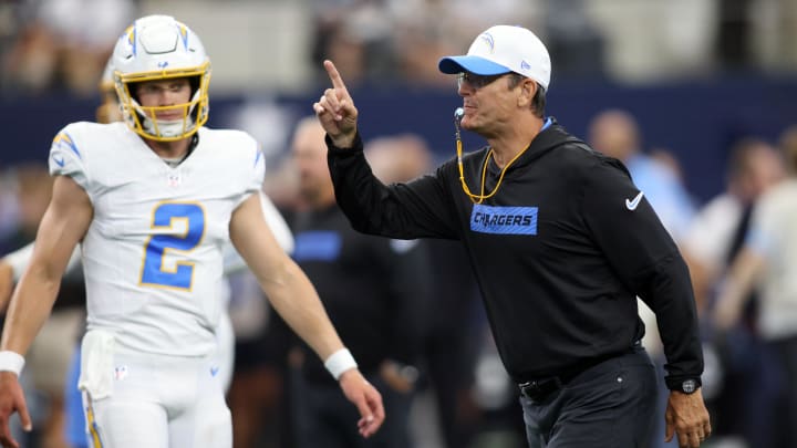 Aug 24, 2024; Arlington, Texas, USA; Los Angeles Chargers head coach Jim Harbaugh blows his whistle before the game against the Dallas Cowboys at AT&T Stadium.