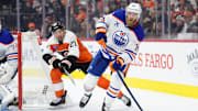 Feb 22, 2025; Philadelphia, Pennsylvania, USA; Edmonton Oilers defenseman Mattias Ekholm (14) passes the puck against the Philadelphia Flyers in the third period at Wells Fargo Center. Mandatory Credit: Kyle Ross-Imagn Images