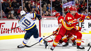 Dec 5, 2024; Calgary, Alberta, CAN; St. Louis Blues center Brayden Schenn (10) is stopped by Calgary Flames goaltender Daniel Vladar (80) during the third period at Scotiabank Saddledome. Mandatory Credit: Brett Holmes-Imagn Images