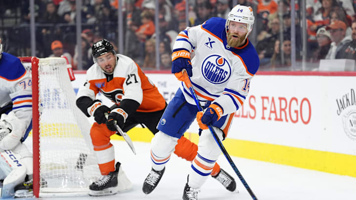Feb 22, 2025; Philadelphia, Pennsylvania, USA; Edmonton Oilers defenseman Mattias Ekholm (14) passes the puck against the Philadelphia Flyers in the third period at Wells Fargo Center. Mandatory Credit: Kyle Ross-Imagn Images
