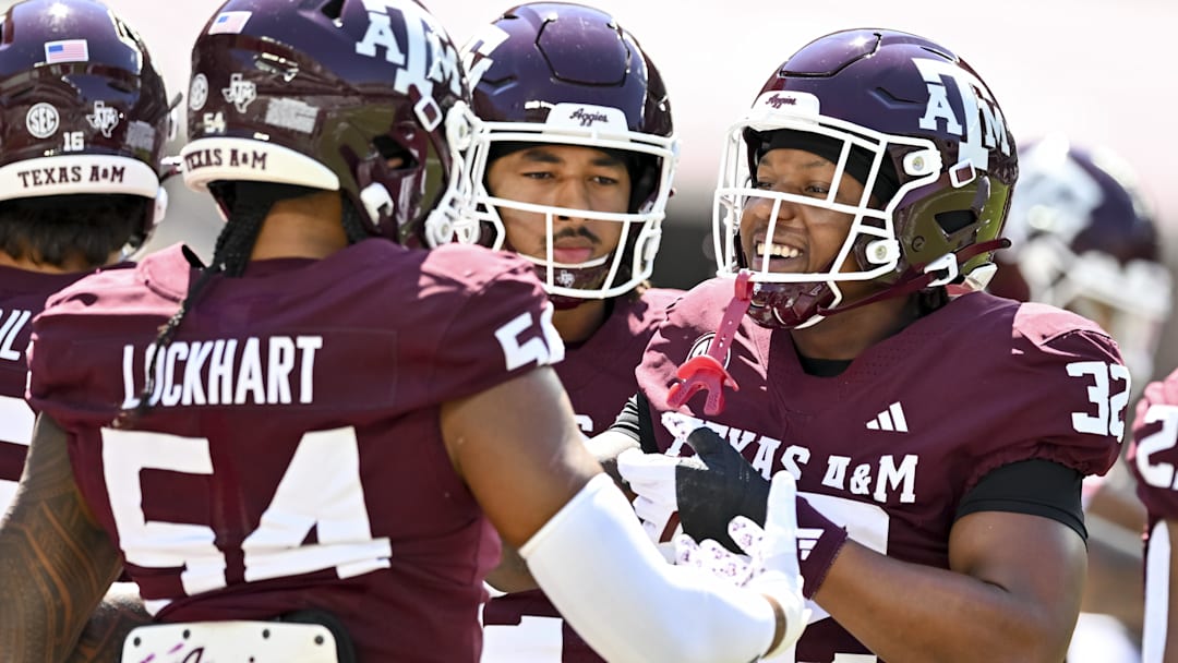 Sep 27, 2025; College Station, Texas, USA; Texas A&M Aggies linebacker Tristan Jernigan (32) greets offensive lineman Mark Nabou Jr. (54) during warm ups prior to the game against the Auburn Tigers at Kyle Field. Mandatory Credit: Maria Lysaker-Imagn Images 