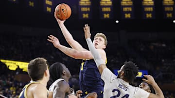 Jan 27, 2025; Ann Arbor, Michigan, USA;  Michigan Wolverines center Danny Wolf (1) shoots over Penn State Nittany Lions forward Zach Hicks (24) in the first half at Crisler Center. Mandatory Credit: Rick Osentoski-Imagn Images