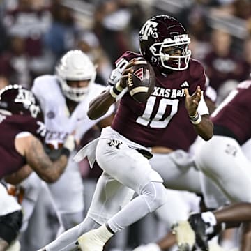 Nov 30, 2024; College Station, Texas, USA; Texas A&M Aggies quarterback Marcel Reed (10) runs the ball during the first half against the Texas Longhorns. The Longhorns defeated the Aggies 17-7 at Kyle Field. Mandatory Credit: Maria Lysaker-Imagn Images  