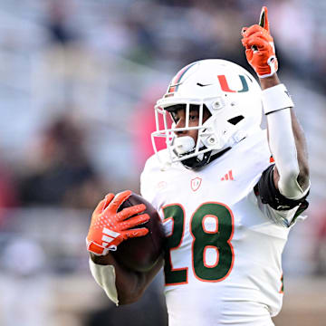 Nov 24, 2023; Chestnut Hill, Massachusetts, USA; Miami Hurricanes running back Ajay Allen (28) reacts after running for a touchdown against the Boston College Eagles during the second half at Alumni Stadium. Mandatory Credit: Brian Fluharty-Imagn Images