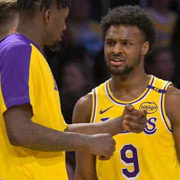 Mar 19, 2025; Los Angeles, California, USA;  Los Angeles Lakers guard Bronny James (9) talks with forward Dorian Finney-Smith (17) during a time out in the second half against the Denver Nuggets at Crypto.com Arena.
