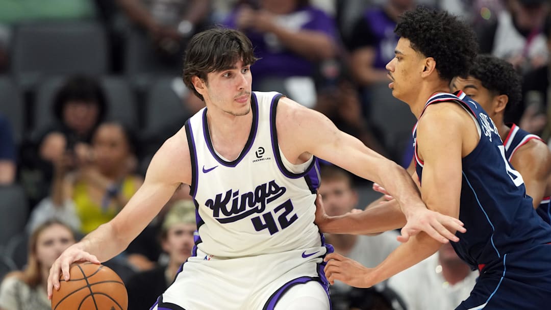Apr 5, 2026; Sacramento, California, USA; Sacramento Kings center Maxime Raynaud (42) dribbles against LA Clippers guard Kobe Sanders (right) during the fourth quarter at Golden 1 Center. Mandatory Credit: Darren Yamashita-Imagn Images