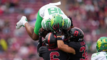 Sep 30, 2023; Stanford, California, USA; Oregon Ducks tight end Kenyon Sadiq (18) attempts to leap over Stanford Cardinal cornerback Collin Wright (6) and safety Mitch Leigber (32) during the second quarter at Stanford Stadium.