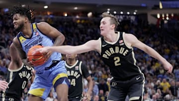 Purdue guard Fletcher Loyer (2) strips the ball from Marquette forward David Joplin (23) during the first half of their game Tuesday, November 19, 2024 at Fiserv Forum in Milwaukee, Wisconsin.