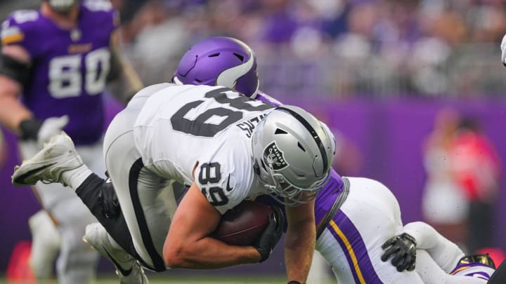 Aug 10, 2024; Minneapolis, Minnesota, USA; Las Vegas Raiders tight end Brock Bowers (89) is tackled against the Minnesota Vikings in the first quarter at U.S. Bank Stadium. Mandatory Credit: Brad Rempel-USA TODAY Sports