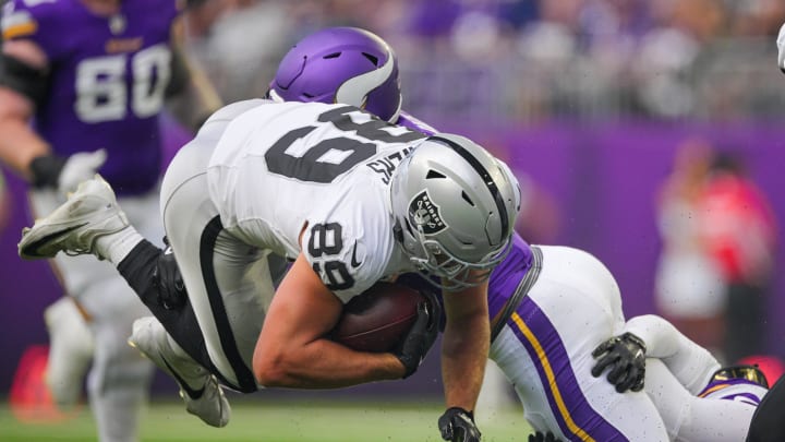 Aug 10, 2024; Minneapolis, Minnesota, USA; Las Vegas Raiders tight end Brock Bowers (89) is tackled against the Minnesota Vikings in the first quarter at U.S. Bank Stadium. Mandatory Credit: Brad Rempel-USA TODAY Sports