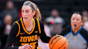 Iowa Hawkeyes guard Lucy Olsen (33) brings the ball up the court Friday, March 7, 2025, in a quarterfinals game at the 2025 TIAA Big Ten Women's Basketball Tournament between the Iowa Hawkeyes and the Ohio State Buckeyes at Gainbridge Fieldhouse in Indianapolis.