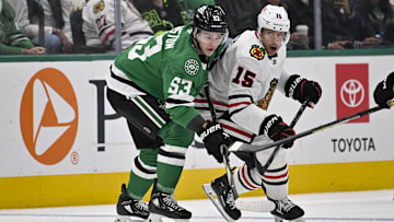 Oct 26, 2024; Dallas, Texas, USA; Dallas Stars center Wyatt Johnston (53) and Chicago Blackhawks center Craig Smith (15) look for the puck during the first period at the American Airlines Center. Mandatory Credit: Jerome Miron-Imagn Images