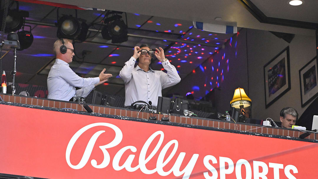 Jul 29, 2024; St. Louis, Missouri, USA; Bally Sports broadcaster Chip Caray talks with broadcaster Jack Buck during the third inning of a game between the St. Louis Cardinals and the Texas Rangers at Busch Stadium. Mandatory Credit: Jeff Curry-Imagn Images Jul 29, 2024; St. Louis, Missouri, USA; Bally Sports broadcaster Chip Caray talks with broadcaster Jack Buck during the third inning of a game between the St. Louis Cardinals and the Texas Rangers at Busch Stadium. Mandatory Credit: Jeff Curry-Imagn Images