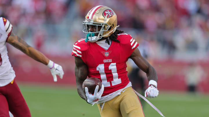 Dec 24, 2022; Santa Clara, California, USA; San Francisco 49ers wide receiver Brandon Aiyuk (11) runs with the ball during the third quarter against the Washington Commanders at Levi's Stadium. Mandatory Credit: Sergio Estrada-USA TODAY Sports