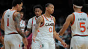 Jan 8, 2025; Coral Gables, Florida, USA; Miami Hurricanes guard Matthew Cleveland (0) high-fives with teammates against the Florida State Seminoles during the second half at Watsco Center. Mandatory Credit: Sam Navarro-Imagn Images