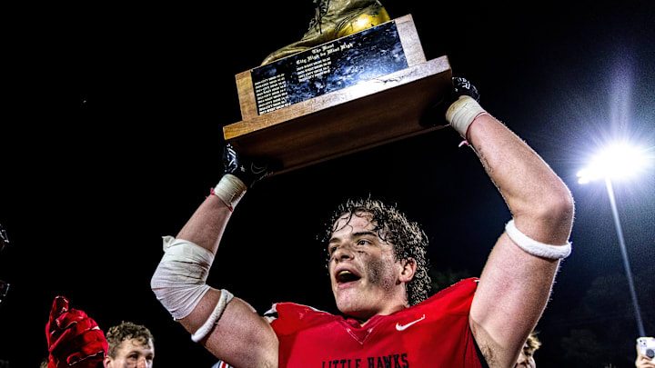 Iowa City High's Sam Kueter, right, holds up The Boot trophy while celebrating with teammate Drew Larson and fans on the field after a Class 5A high school football game in the Battle for the Boot against Iowa City West, Friday, Sept. 15, 2023, at Frank Bates Field in Iowa City, Iowa. City High won, 23-8. Iowa City High's Sam Kueter, right, holds up The Boot trophy while celebrating with teammate Drew Larson and fans on the field after a Class 5A high school football game in the Battle for the Boot against Iowa City West, Friday, Sept. 15, 2023, at Frank Bates Field in Iowa City, Iowa. City High won, 23-8.