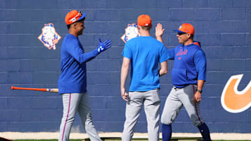 Feb 16, 2025; Port St. Lucie, FL, USA; New York Mets outfielder Juan Soto (22) greets assistant pitching coach Desi Druschel, right, and vice president of pitching, Eric Jagers on his first day of spring training with the Mets. Mandatory Credit: Jim Rassol-Imagn Images