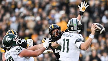 Nov 22, 2025; Iowa City, Iowa, USA; Iowa Hawkeyes defensive end Max Llewellyn (center with arm raised) rushes Michigan State Spartans quarterback Alessio Milivojevic (11) as offensive lineman Conner Moore (58) blocks during the second quarter at Kinnick Stadium. Mandatory Credit: Jeffrey Becker-Imagn Images