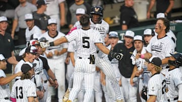 Vanderbilt infielder Mike Mancini (5) celebrates with Vanderbilt utility RJ Austin (42) after hitting a home run during a NCAA baseball game between the Tennessee Volunteers and Vanderbilt Commodores at Lindsey Nelson Stadium on May 11, 2025. Vanderbilt won 7-5 against Tennessee.