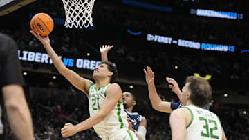 Mar 21, 2025; Seattle, WA, USA; Oregon Ducks forward Brandon Angel (21) shoots the ball against the Liberty Flames during the first half in the first round of the NCAA Tournament  at Climate Pledge Arena. Mandatory Credit: Stephen Brashear-Imagn Images