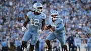 Nov 22, 2025; Chapel Hill, North Carolina, USA;  North Carolina Tar Heels quarterback Gio Lopez (7) rushes around the end during the first half against the Duke Blue Devils at Kenan Stadium. Mandatory Credit: William Howard-Imagn Images