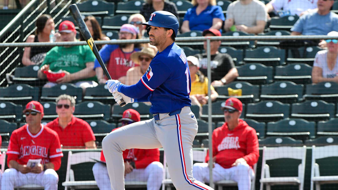 Feb 23, 2026; Tempe, Arizona, USA;  Texas Rangers second baseman Tyler Wade (14) hits a RBI single in the first inning against the Los Angeles Angels during a spring training game at Tempe Diablo Stadium. Mandatory Credit: Matt Kartozian-Imagn Images
