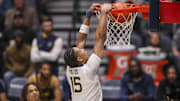 Dec 3, 2025; Morgantown, West Virginia, USA; West Virginia Mountaineers forward Jackson Fields (15) dunks during the first half against the Coppin State Eagles at Hope Coliseum. Mandatory Credit: Ben Queen-Imagn Images