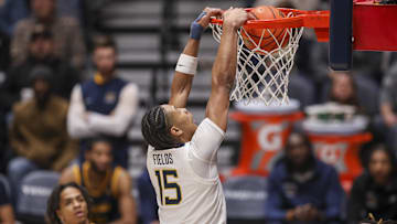 Dec 3, 2025; Morgantown, West Virginia, USA; West Virginia Mountaineers forward Jackson Fields (15) dunks during the first half against the Coppin State Eagles at Hope Coliseum. Mandatory Credit: Ben Queen-Imagn Images