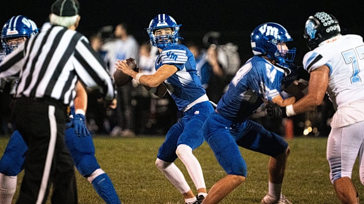 Van Meter's Henry Lounsbury looks to attempt a pass during a first round playoff football game at Van Meter High School on Friday, Oct. 24, 2025, in Van Meter.