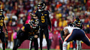 Oct 27, 2024; Landover, Maryland, USA; Washington Commanders quarterback Jayden Daniels (5) calls out at the line of scrimmage during the second half against the Chicago Bears at Commanders Field. Mandatory Credit: Peter Casey-Imagn Images