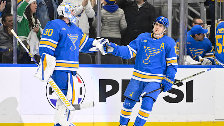 Dec 9, 2025; St. Louis, Missouri, USA; St. Louis Blues center Robert Thomas (18) is congratulated by goaltender Joel Hofer (30) after scoring against the Boston Bruins during the first period at Enterprise Center. Mandatory Credit: Jeff Curry-Imagn Images