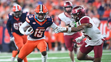 Sep 12, 2025; Syracuse, New York, USA; Syracuse Orange wide receiver Darrell Gill Jr. (15) tries to avoid a tackle by Colgate Raiders defensive back Tymir Wynn (6) in the first quarter at the JMA Wireless Dome. Mandatory Credit: Mark Konezny-Imagn Images
