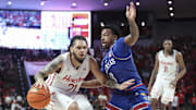Mar 3, 2025; Houston, Texas, USA; Houston Cougars guard Emanuel Sharp (21) drives with the ball as Kansas Jayhawks guard David Coit (8) defends during the second half at Fertitta Center.