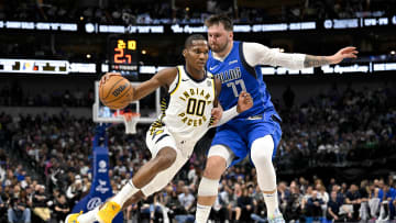 Mar 5, 2024; Dallas, Texas, USA; Indiana Pacers guard Bennedict Mathurin (00) brings the ball up court past Dallas Mavericks guard Luka Doncic (77) during the second half at the American Airlines Center. Mandatory Credit: Jerome Miron-USA TODAY Sports