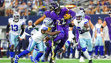 Sep 22, 2024; Arlington, Texas, USA; Baltimore Ravens running back Derrick Henry (22) runs during the first half as Dallas Cowboys safety Donovan Wilson (6) and Dallas Cowboys cornerback Jourdan Lewis (2) defend at AT&T Stadium.