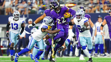 Sep 22, 2024; Arlington, Texas, USA; Baltimore Ravens running back Derrick Henry (22) runs during the first half as Dallas Cowboys safety Donovan Wilson (6) and Dallas Cowboys cornerback Jourdan Lewis (2) defend at AT&T Stadium. Mandatory Credit: Kevin Jairaj-Imagn Images